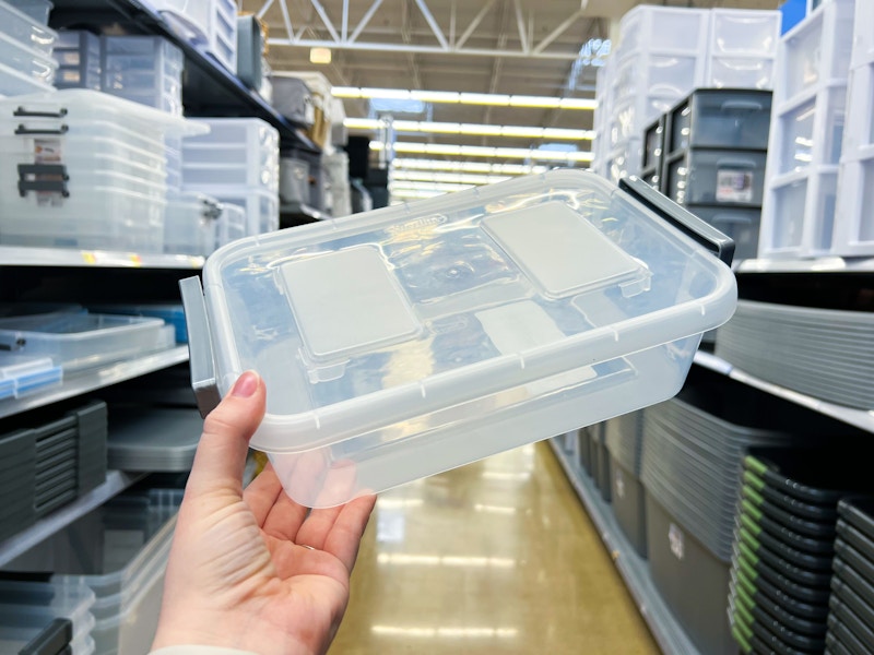 hand holding sterilite latch box in walmart aisle