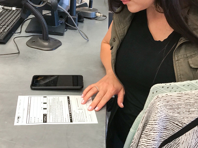 Someone reading a form on the counter at Plato's Closet