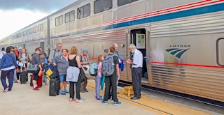 People lined up to show their tickets and get onto the Amtrak train