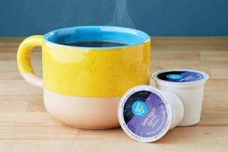 Amazon Brand - Happy Belly Dark Roast Coffee Pods on a kitchen counter.