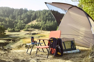 an outdoor scene of a tent and table