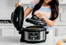 person cooking with the Ninja Food pressure cooker in a kitchen