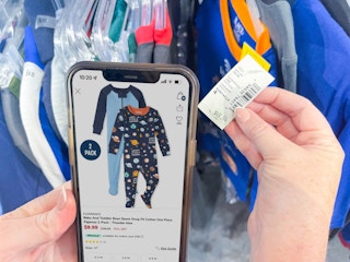 a person holding cellphone comparing on the price tag