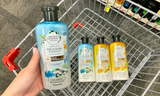 hand holding bottle of Herbal Essences: bio renew shampoo