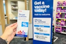 hand holding a coupon flyer for $5 off your $20 purchase with vaccination at CVS pharmacy 