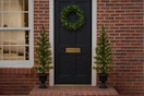 two pre-lit trees and wreath
