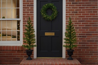 two pre-lit trees and wreath