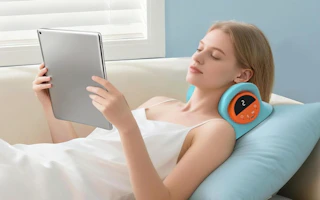 a person laying on a neck massager