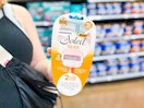 woman holding a pack of bic soleil 5 glide razors in walmart aisle