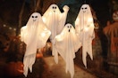 four lighted ghosts outdoors