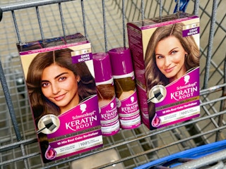two boxes of schwarzkopf hair color and two bottles of spray in walmart cart
