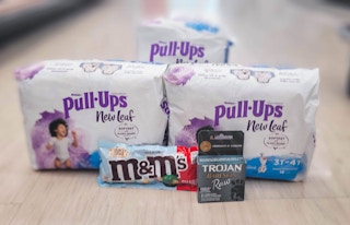three packs of Pull-Ups New Leaf, M&M's, and a pack of Trojan in aisle