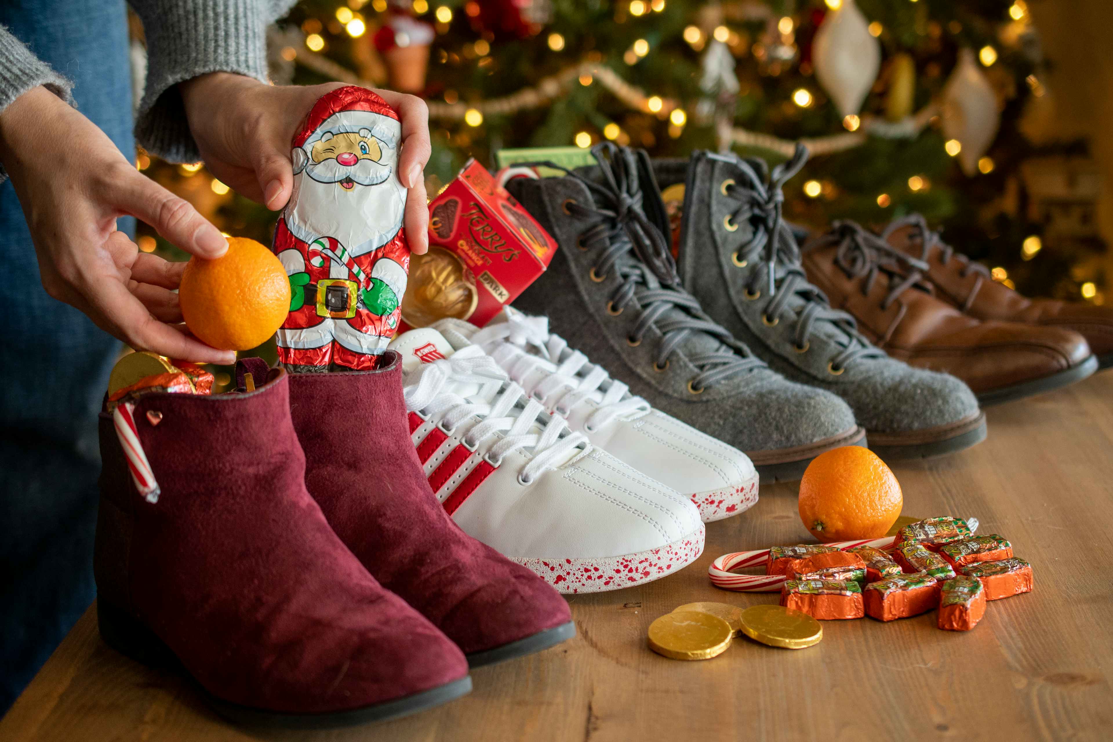 4 pairs of shoes filled with candy and oranges