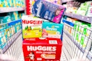 huggies, goodnites, and pampers stacked in a shopping cart