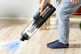 a boy using a vacuum handheld