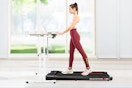 Lifestyle image of women using a Gearstone walking pad under desk in-doors