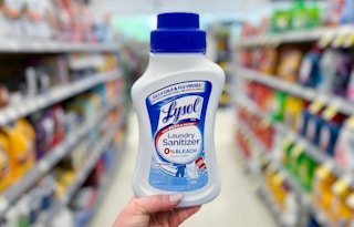 hand holding lysol laundry sanitizer