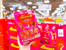 hand holding a bag of reeses hearts