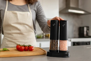 a woman holding a salt and pepper grinder