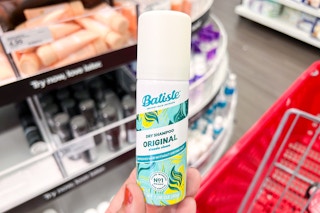 hand holding a bottle of batiste dry shampoo at target