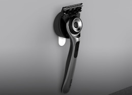 a razor hanging on a wall hook
