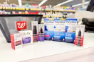 olay and clearblue products next to a walgreens shopping basket