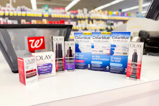 olay and clearblue products next to a walgreens shopping basket