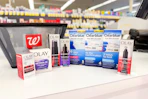 olay and clearblue products next to a walgreens shopping basket