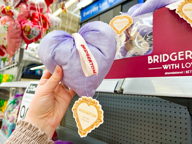 hand holding bridgerton heart pillow at walmart