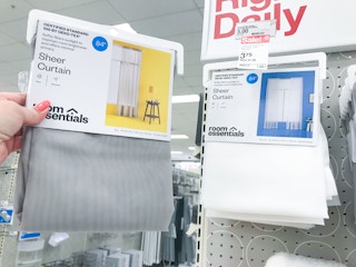 hand holding gray room essentials sheer curtain at target