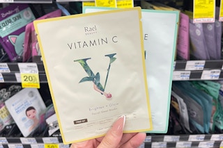 hand holding two Rael sheet masks