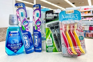 crest mouthwash, 2 oral-b manual toothbrushes, Dove shampoo, and Gillette disposable razors on store counter