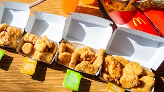 40 piece chicken nugget meal all boxes open to show 10 nuggets per box along with sweat and sour and honey mustard sauce