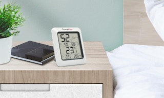 an indoor thermometer/hygrometer on a nightstand