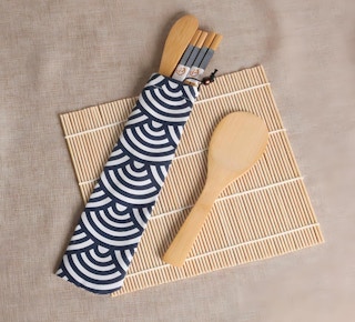 a bamboo sushi kit on a tablecloth