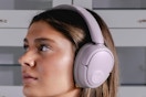 Woman wearing the JLab JBuds Lux ANC Wireless Headphones.