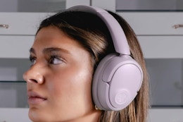 Woman wearing the JLab JBuds Lux ANC Wireless Headphones.