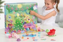 a girl playing with a baby shark advent calendar
