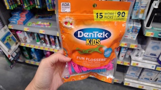 hand holding pack of dentek kids