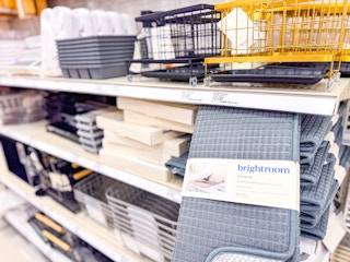 hand holding drying mat in front of brightroom kitchen storage on shelf at target