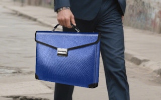 a person carrying a blue document bag