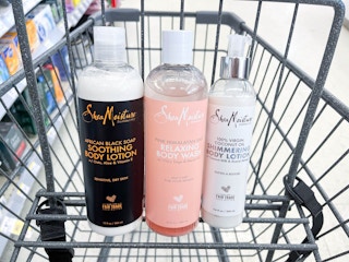 three bottles of Shea Moisture body care products inside shopping cart