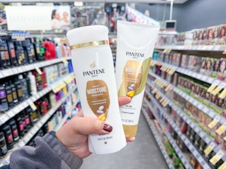 hand holding pantene hair care items in walgreens