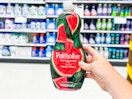 hand holding a bottle of palmolive dish soap in a target aisle