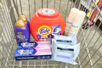 tide pods, batiste dry shampoo, neutrogena makeup wipes, ogx shampoo, and crest toothpaste in a cart