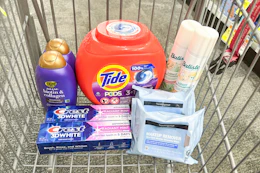 tide pods, batiste dry shampoo, neutrogena makeup wipes, ogx shampoo, and crest toothpaste in a cart