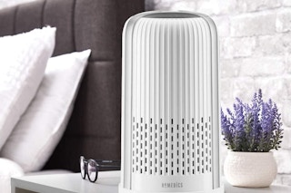 An air purifier on a bedroom table
