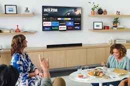 people watching a tv on a wall