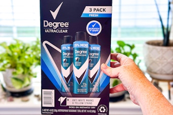 hand holding a box of degree dry spray deodorant