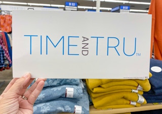 hand holding time and tru logo at walmart